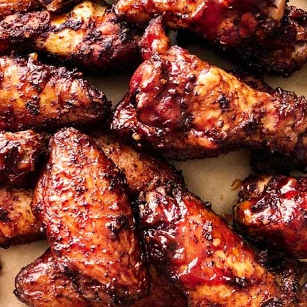 Insanely tasty chicken wing recipe, dry rubbed, then hickory smoked to perfection.  And don't forget the homemade bourbon bbq sauce! #chickenwings #wingrecipe #smoked #smoker #smokedchickenwings #bourbon #bbq #crispy